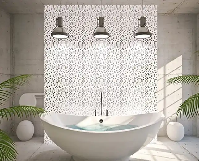 A bathroom with three lights and a large white tub.