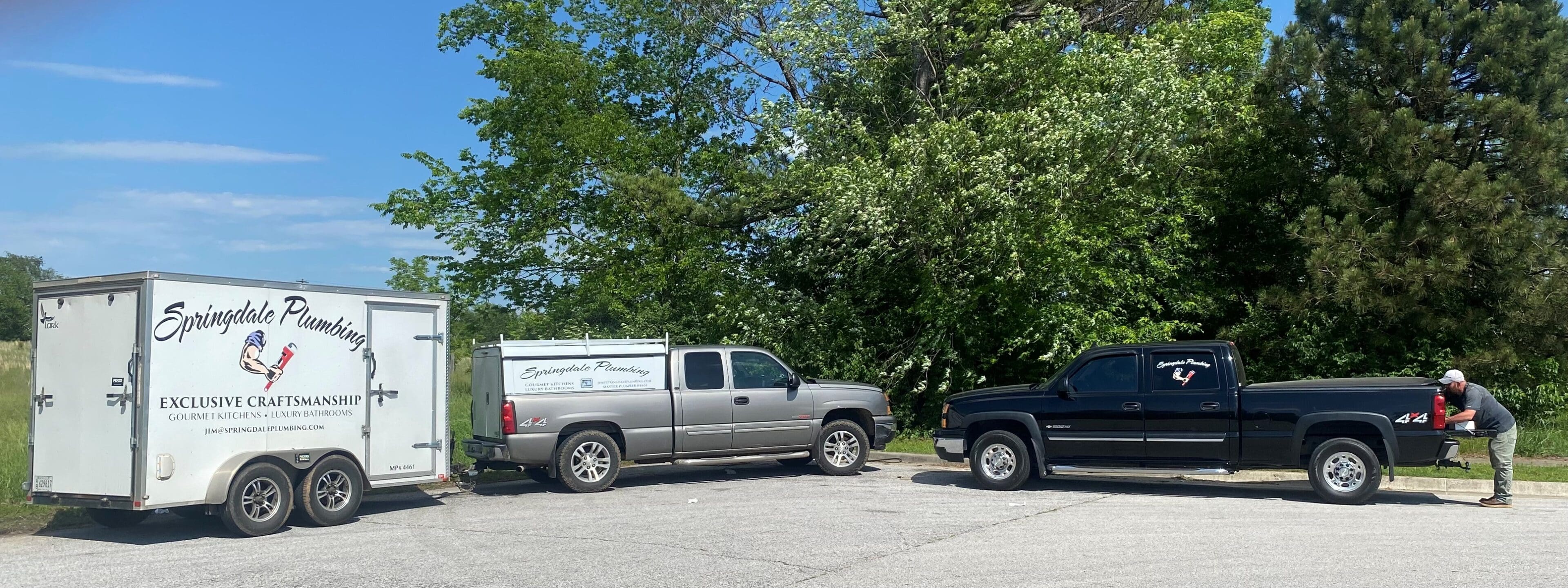 A truck parked in the parking lot next to another truck.